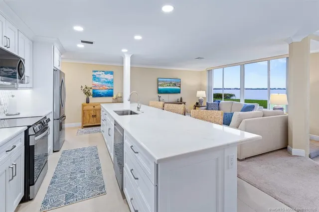 a living room with furniture and large windows