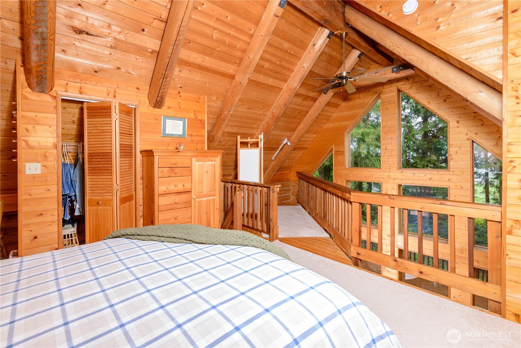214 Cougar Crest Road Sequim, WA 98382 - Photo 17 of 30 a bedroom with a bed and wooden floor
