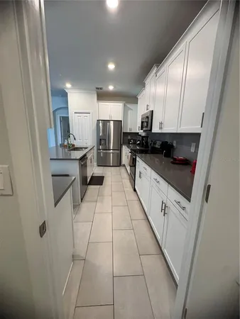 a kitchen with stainless steel appliances granite countertop a sink and cabinets