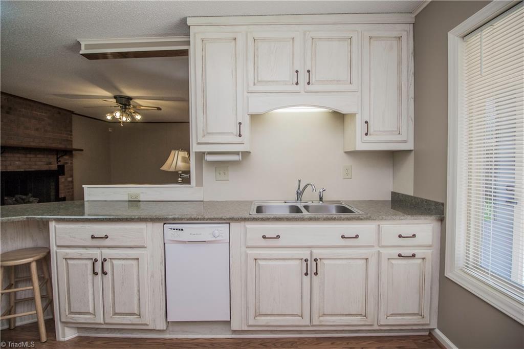772 Bescher Chapel Road Trinity, NC 27370 - Photo 4 of 29 The compact dishwasher cabinet has side panels that remove easily to accommodate a full-size dishwasher.