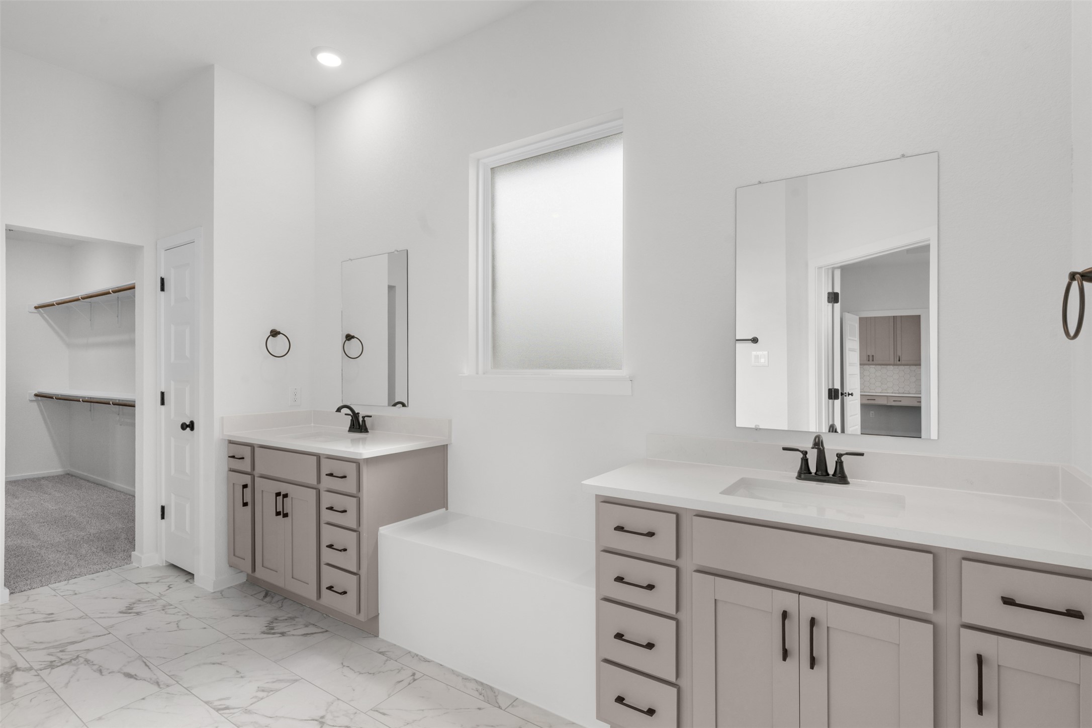 405 Raleigh Drive Georgetown, TX 78633 - Photo 11 of 27 Full bathroom with two vanities, light marble finish flooring, and a spacious closet