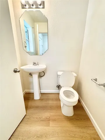a bathroom with a sink toilet and mirror