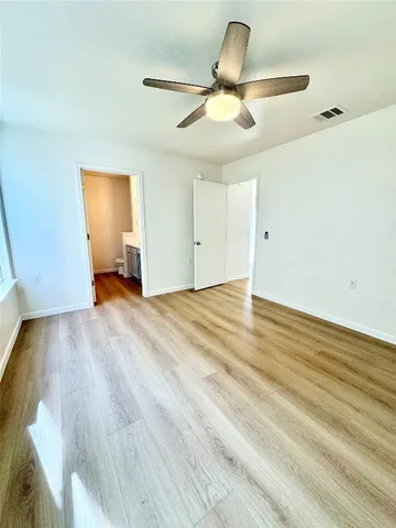 a view of an empty room and wooden floor