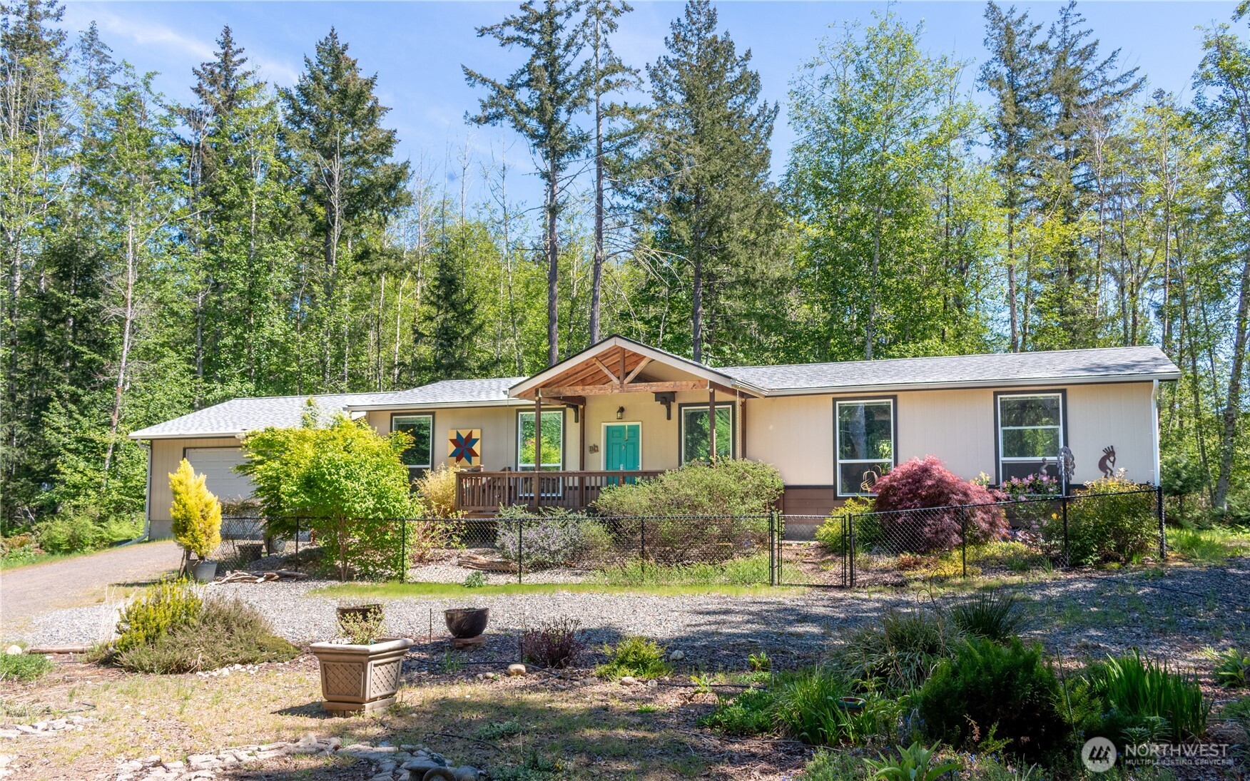 3111 East Rasor Road Belfair, WA 98528 - Photo 1 of 26 a front view of a house with garden
