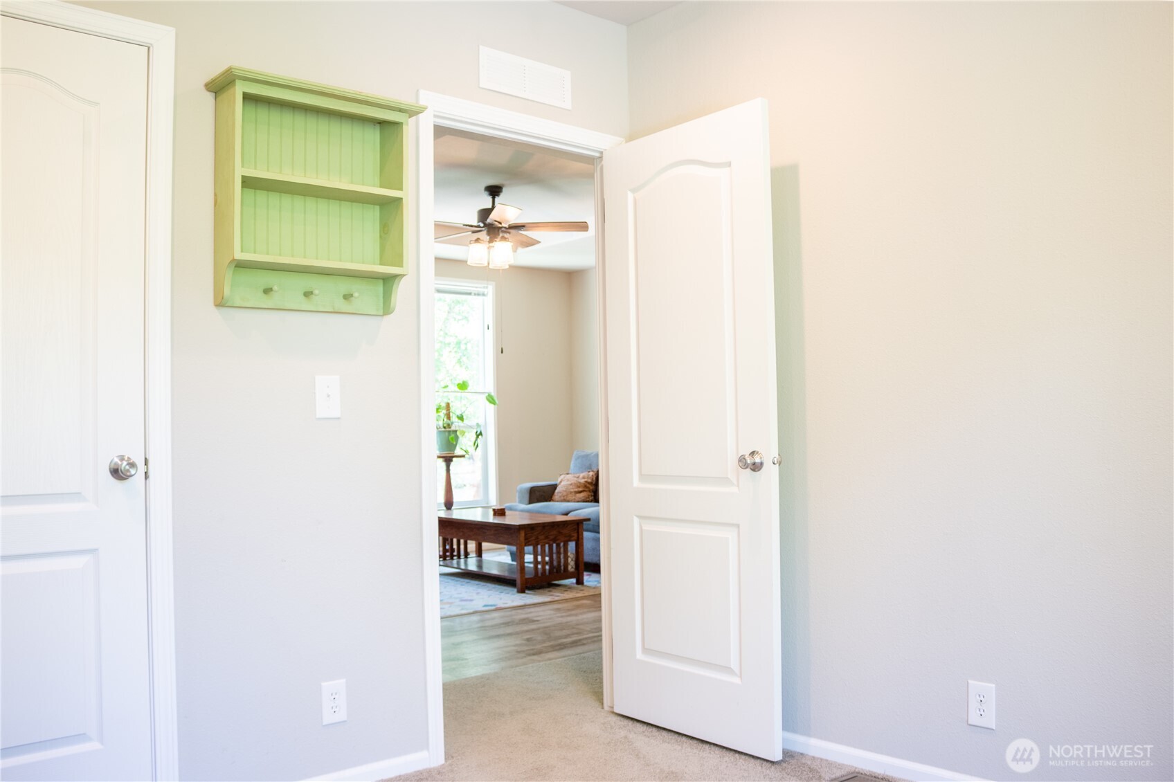 3111 East Rasor Road Belfair, WA 98528 - Photo 18 of 26 a view of a hallway to a livingroom with furniture and a window
