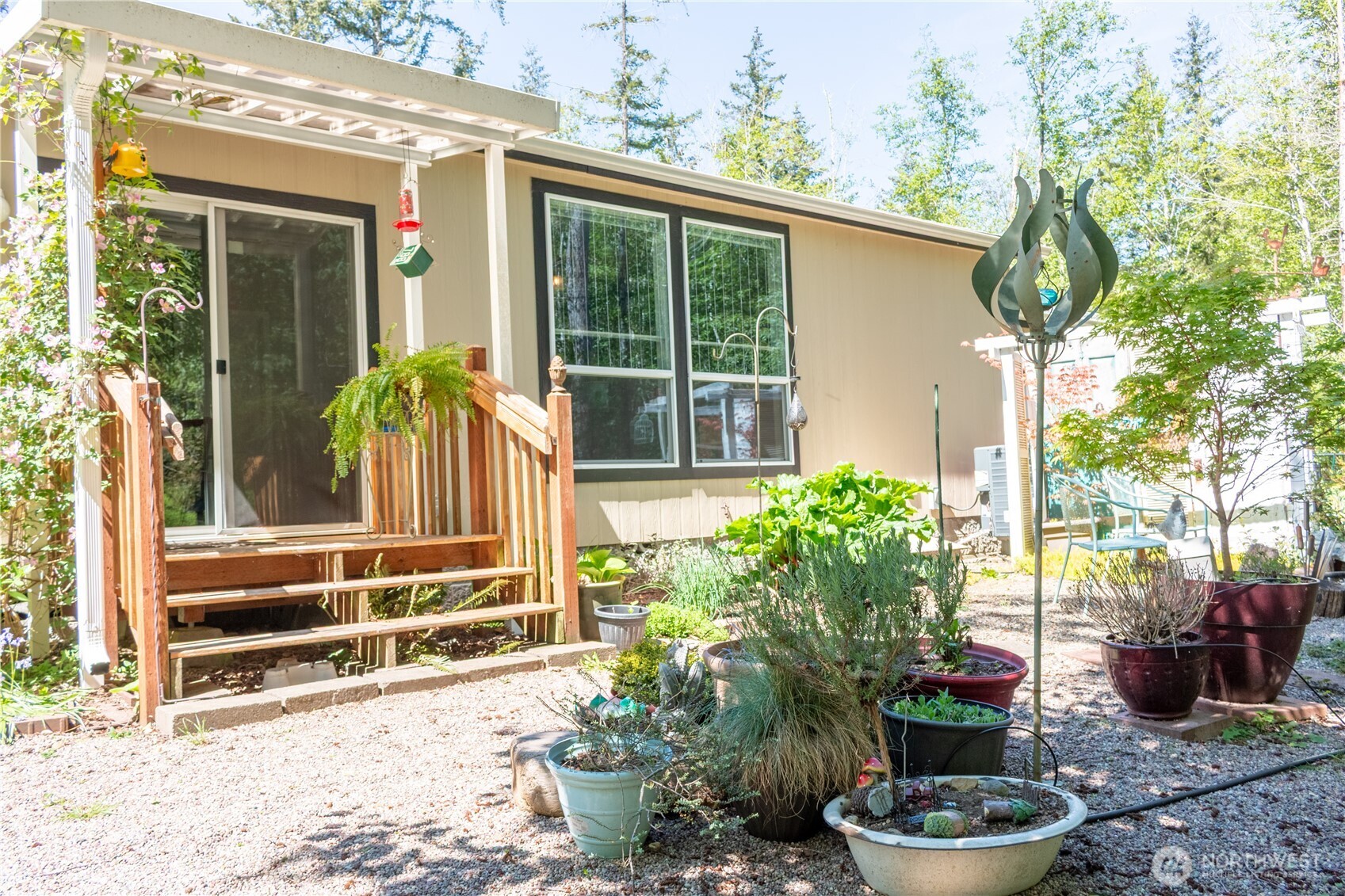 3111 East Rasor Road Belfair, WA 98528 - Photo 22 of 26 a view of a porch with chairs and potted plants