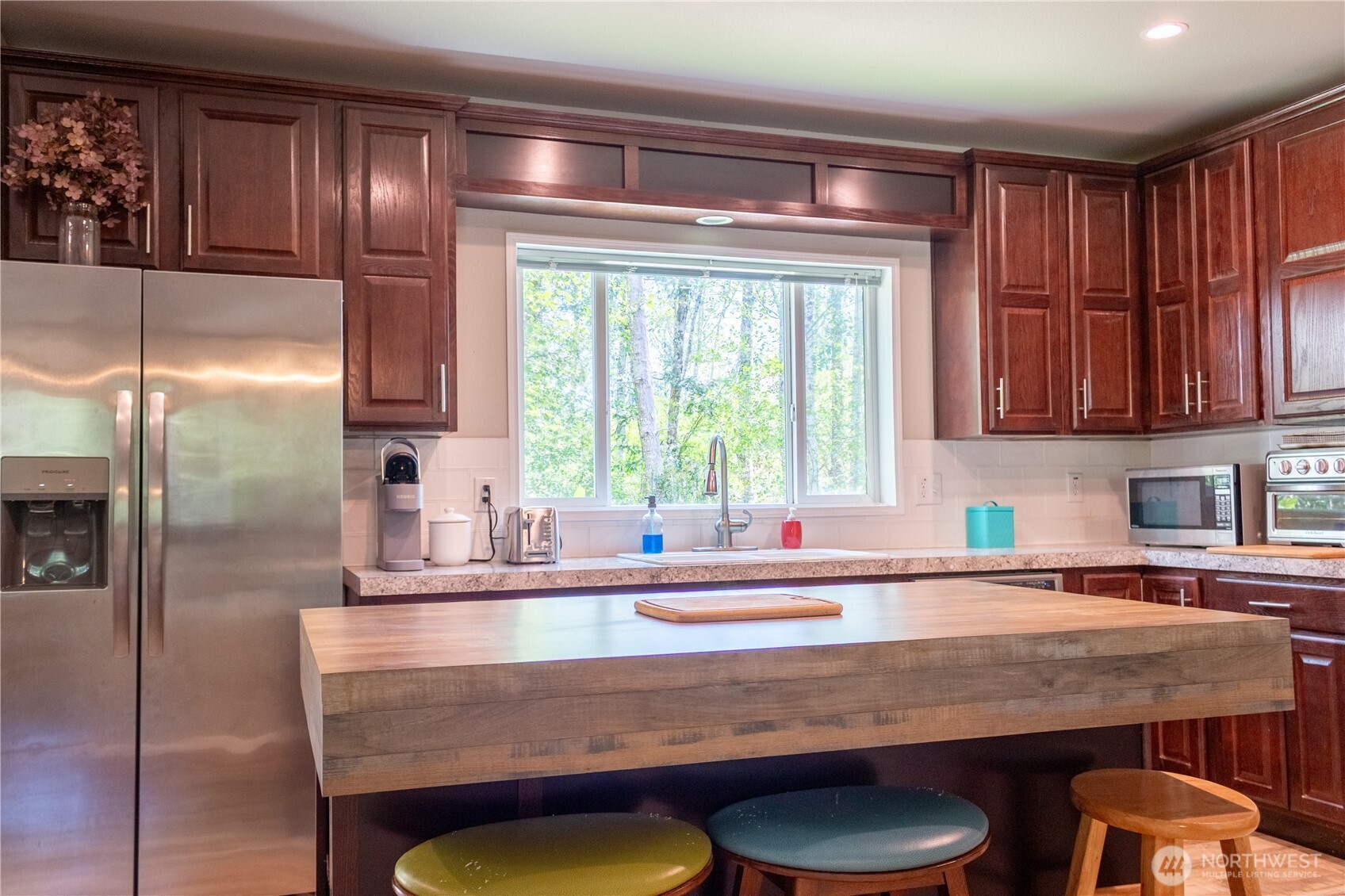 3111 East Rasor Road Belfair, WA 98528 - Photo 6 of 26 a kitchen with granite countertop a sink a stove and a dining table