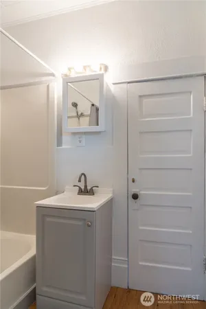 a bathroom with a sink a vanity and a bathtub