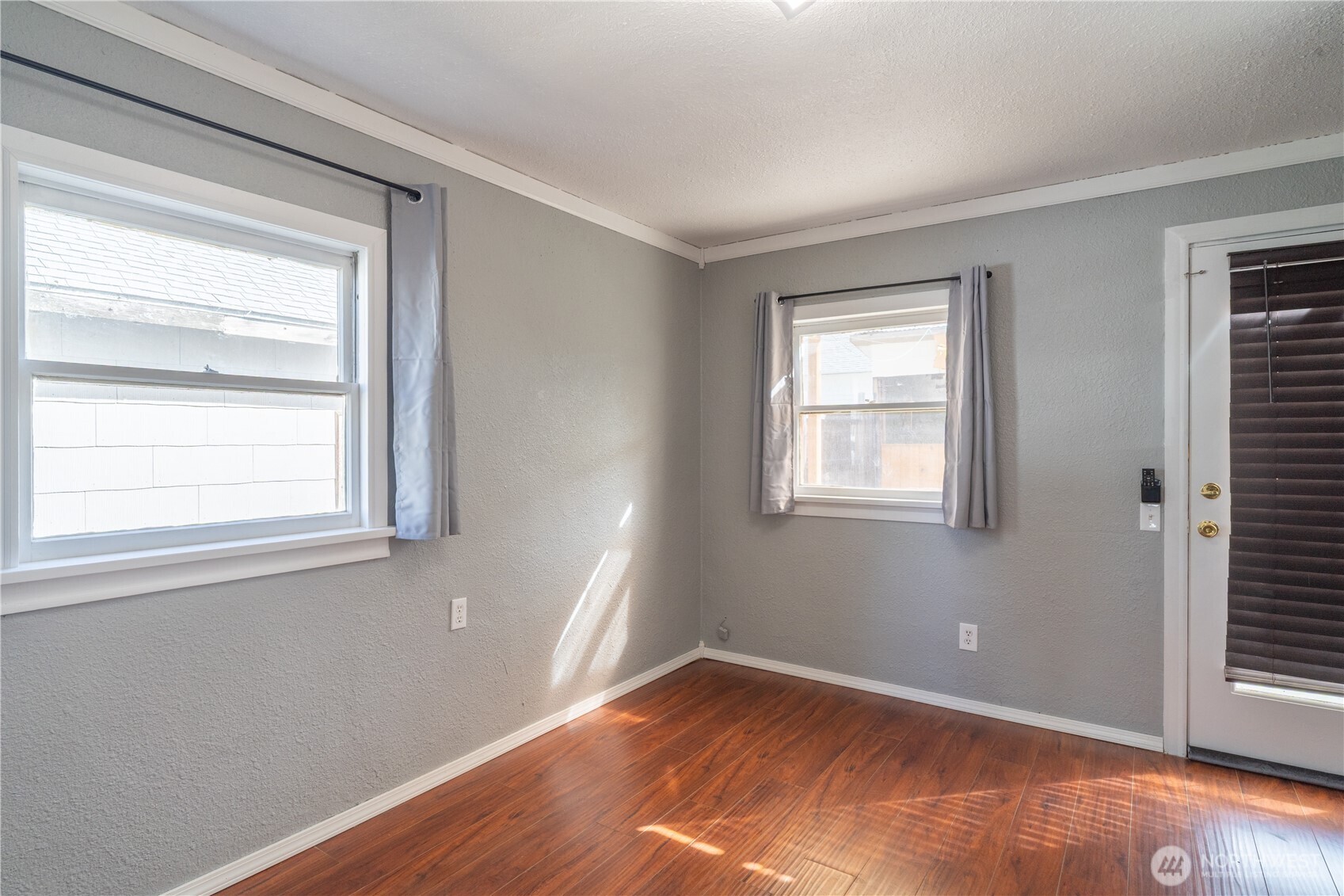 105 West 5th Avenue Ritzville, WA 99169 - Photo 17 of 40 a view of an empty room with wooden floor and a window