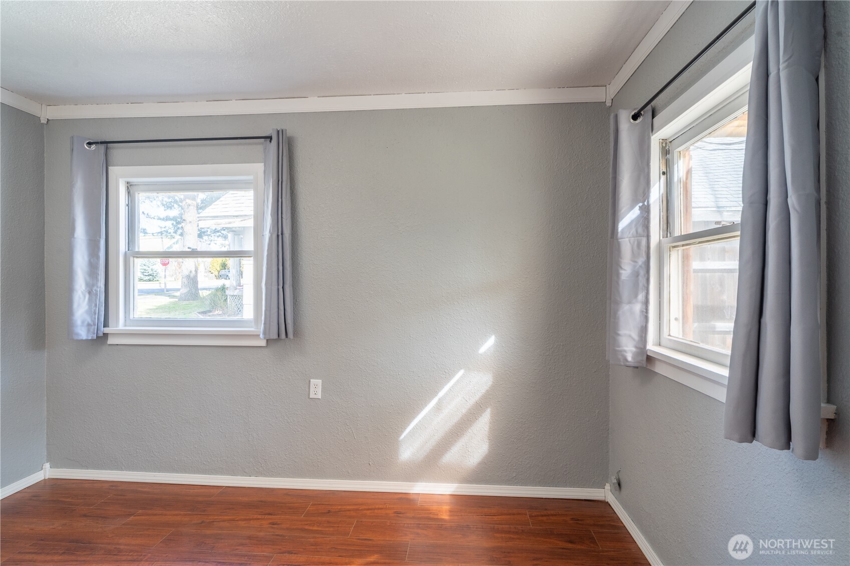 105 West 5th Avenue Ritzville, WA 99169 - Photo 20 of 40 a view of an empty room with wooden floor and a window