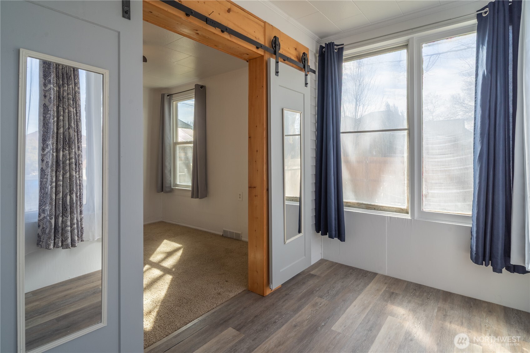 105 West 5th Avenue Ritzville, WA 99169 - Photo 25 of 40 a view of an empty room with wooden floor and a window