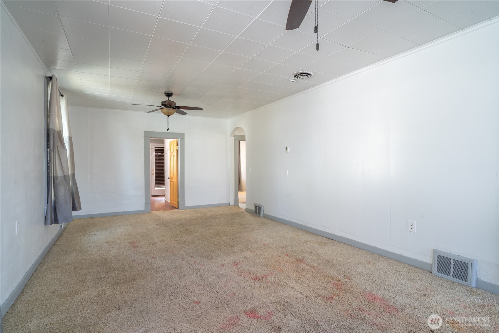 105 West 5th Avenue Ritzville, WA 99169 - Photo 4 of 40 a view of a livingroom with a chandelier fan and windows
