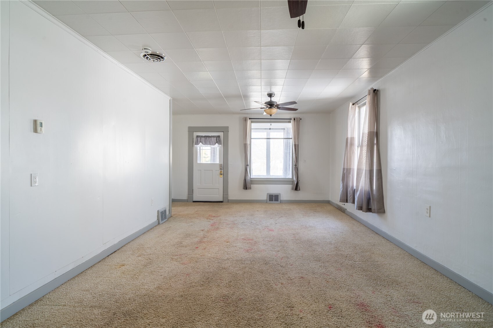 105 West 5th Avenue Ritzville, WA 99169 - Photo 5 of 40 an empty room with chandelier fan and windows