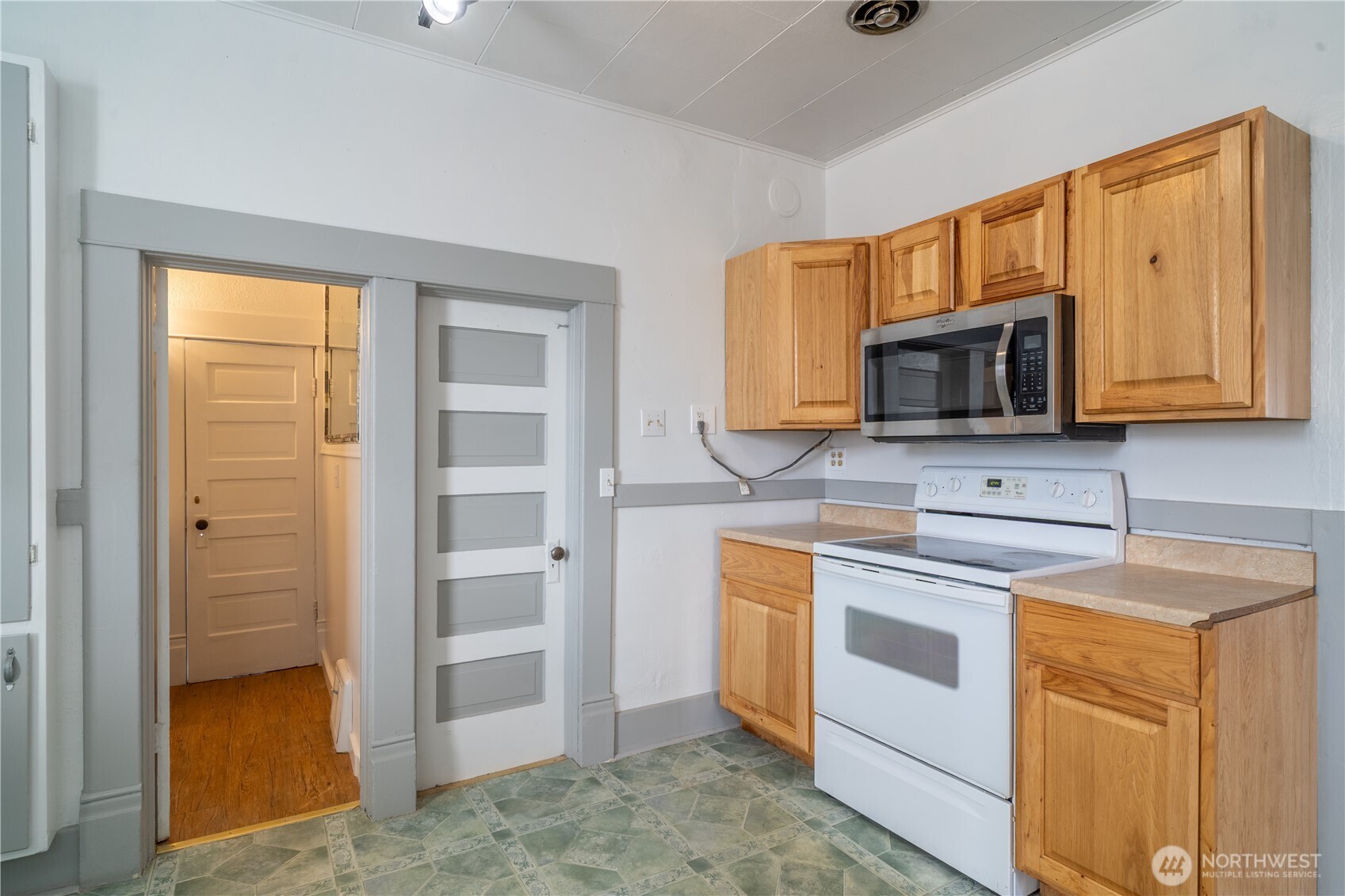 105 West 5th Avenue Ritzville, WA 99169 - Photo 9 of 40 a kitchen with stainless steel appliances granite countertop a stove microwave and refrigerator