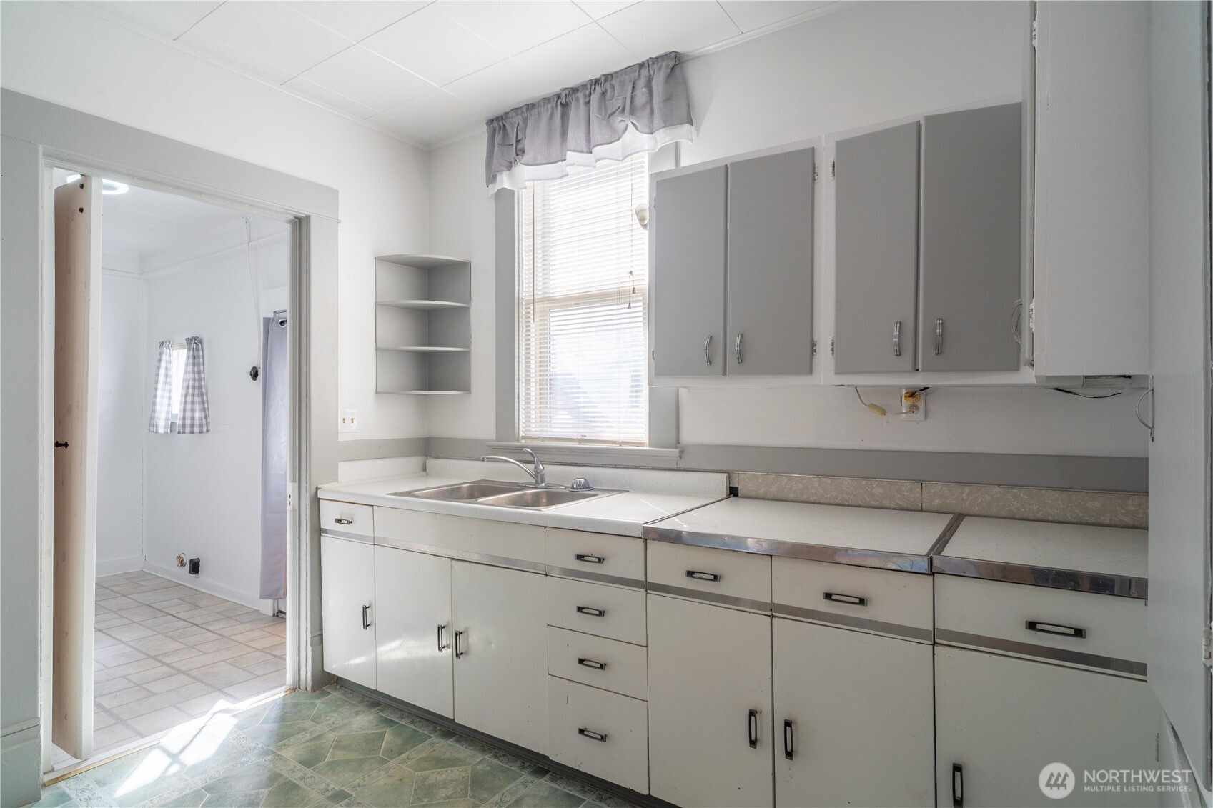 105 West 5th Avenue Ritzville, WA 99169 - Photo 10 of 40 a kitchen with granite countertop a sink window and cabinets