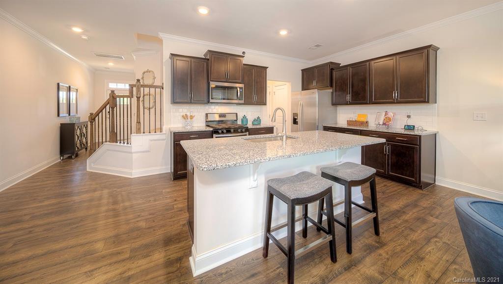 313 Bulrush Rd Lake Lake Wylie, SC 29710 - Photo 11 of 39 a large kitchen with a table and chairs in it