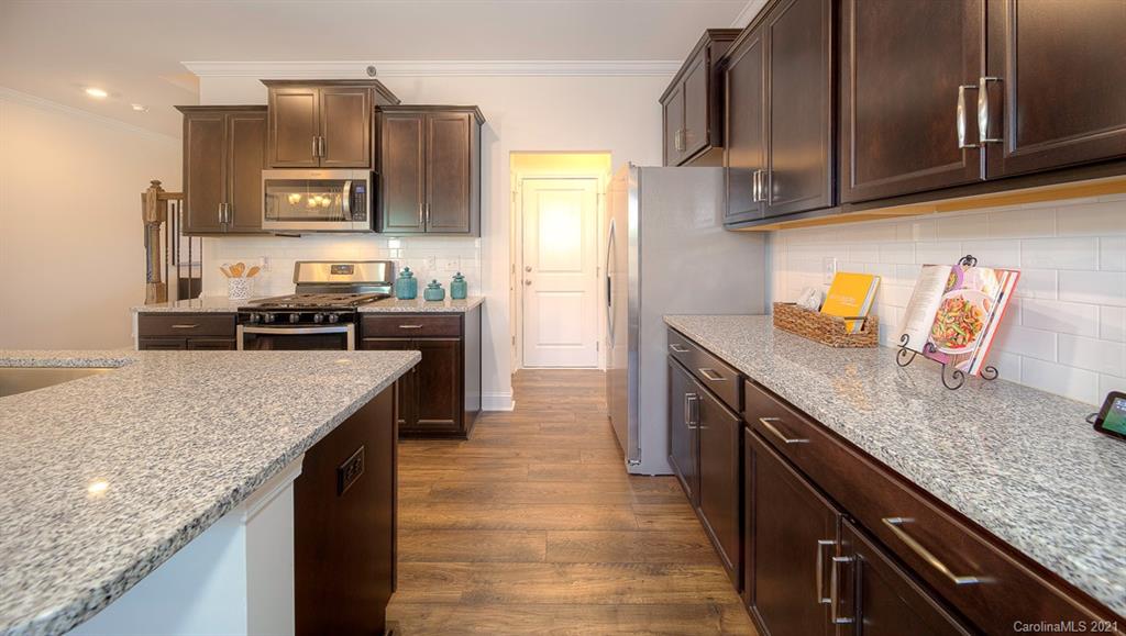 313 Bulrush Rd Lake Lake Wylie, SC 29710 - Photo 13 of 39 a kitchen with granite countertop stainless steel appliances and wooden cabinets