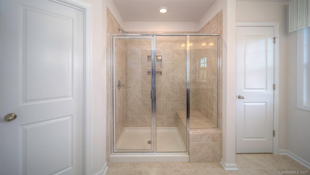 313 Bulrush Rd Lake Lake Wylie, SC 29710 - Photo 16 of 39 a bathroom with a glass shower door