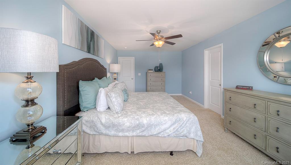 313 Bulrush Rd Lake Lake Wylie, SC 29710 - Photo 20 of 39 a bed room with a bed mirror and a lamp