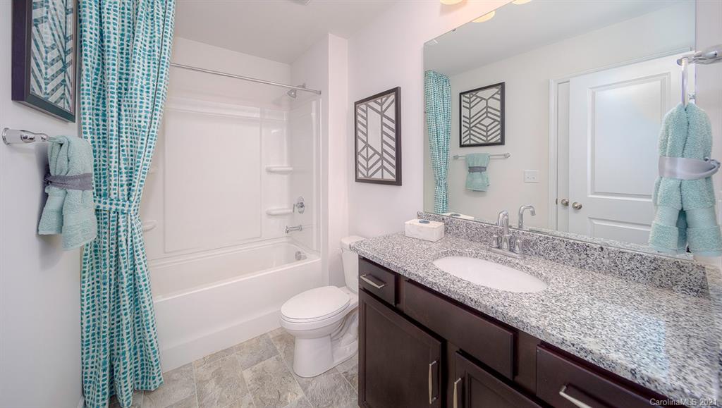 313 Bulrush Rd Lake Lake Wylie, SC 29710 - Photo 21 of 39 a bathroom with a granite countertop sink a toilet and shower