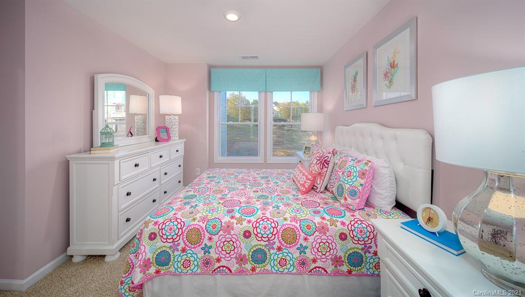 313 Bulrush Rd Lake Lake Wylie, SC 29710 - Photo 22 of 39 a bedroom with a bed and a dresser next to a window
