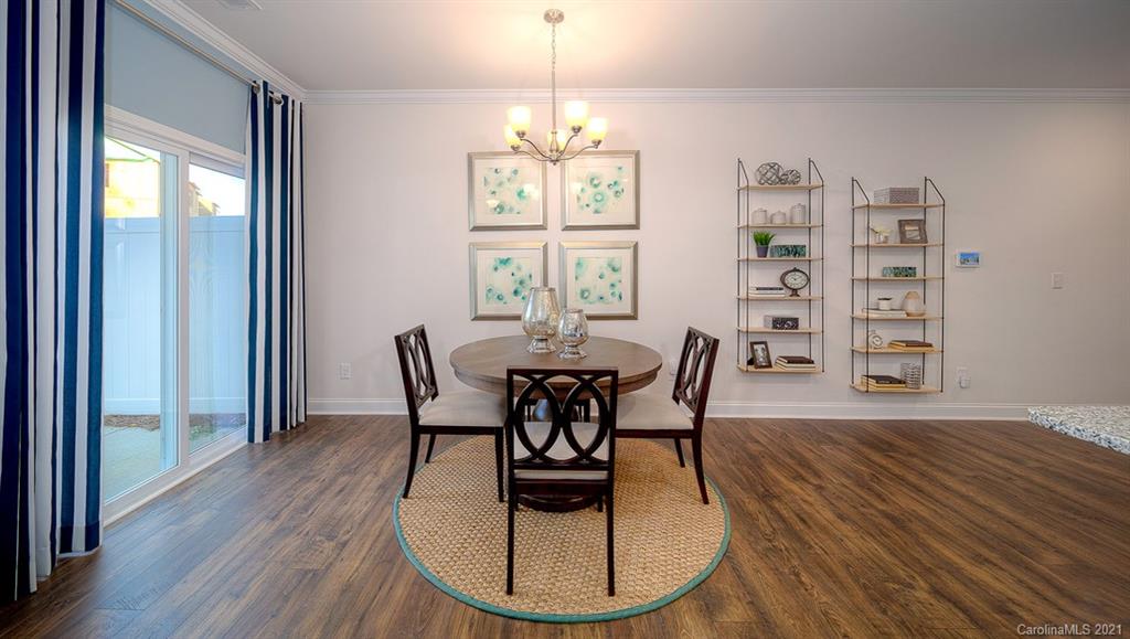 313 Bulrush Rd Lake Lake Wylie, SC 29710 - Photo 5 of 39 a dining room with wooden floor a chandelier a glass table and chairs