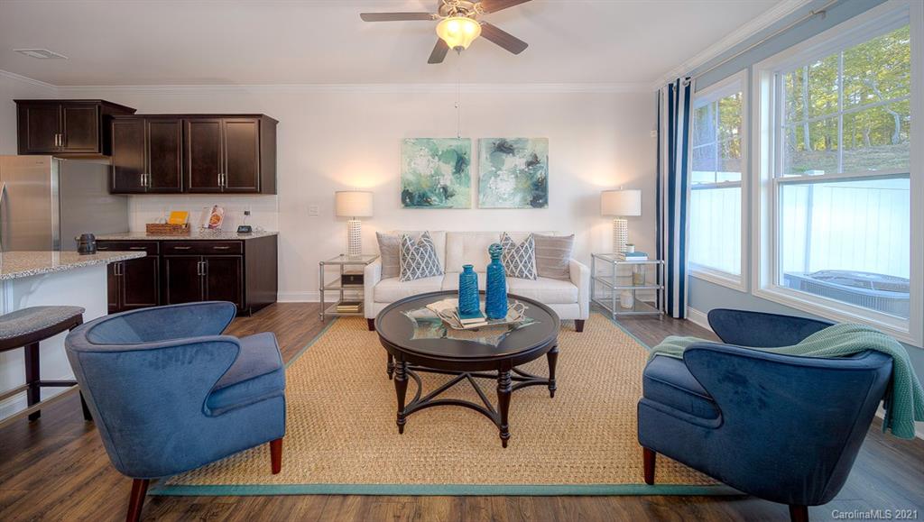313 Bulrush Rd Lake Lake Wylie, SC 29710 - Photo 7 of 39 a living room with furniture a flat screen tv and a large window