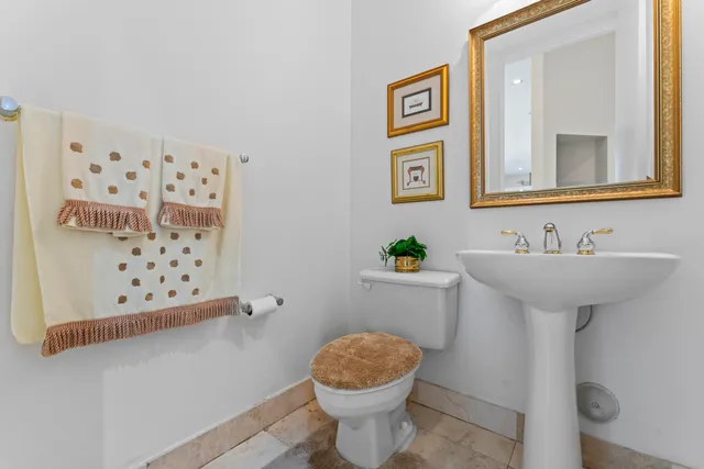 a bathroom with a sink toilet and mirror