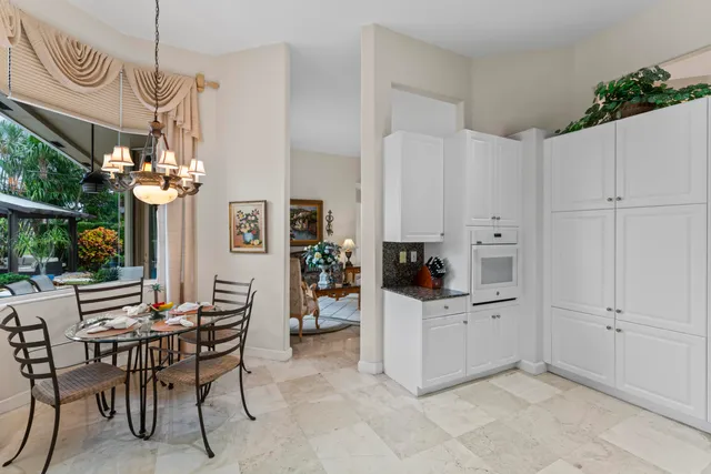 a view of kitchen with furniture and chandelier