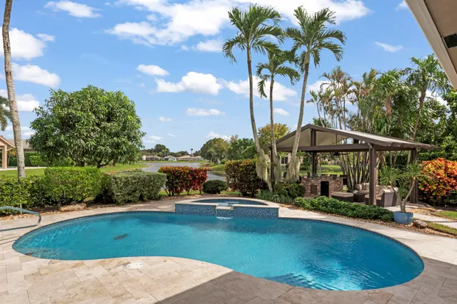 a view of swimming pool with outdoor seating and plants