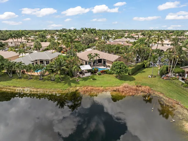 an aerial view of a house with swimming pool and garden view