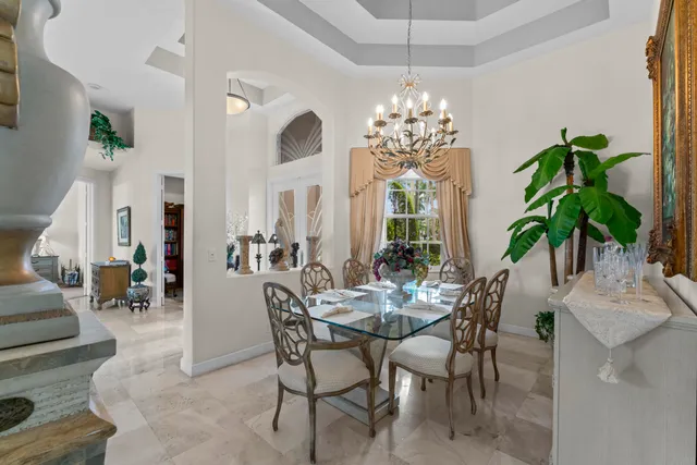 a view of a dining room with furniture and chandelier
