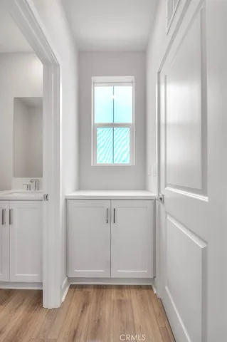 a bathroom with a granite countertop toilet a sink and a mirror