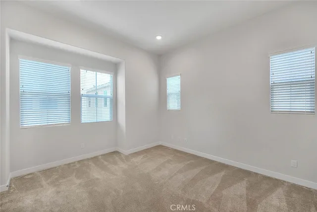 a view of a kitchen with white cabinets and wooden floor