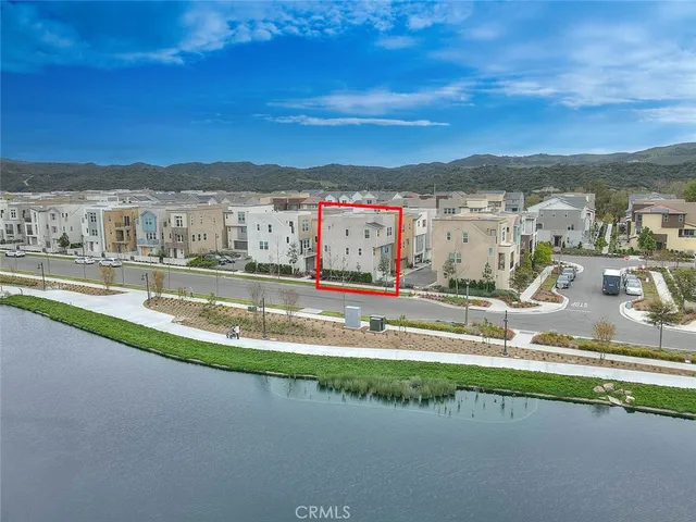 an aerial view of residential building and lake