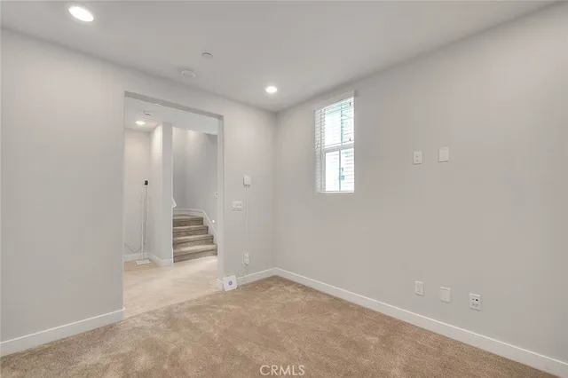 a large kitchen with granite countertop a stove top oven a sink and white cabinets