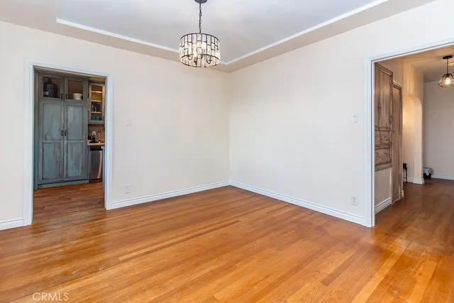 a view of a hallway with wooden floor and a table