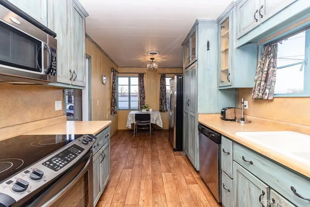 a kitchen with a sink cabinets and a window