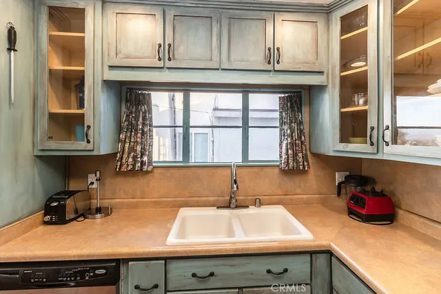 a kitchen with a refrigerator and a sink