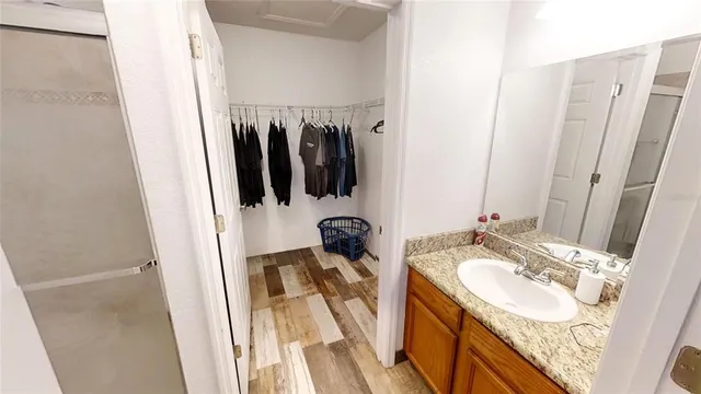 a bathroom with a sink tub and a mirror