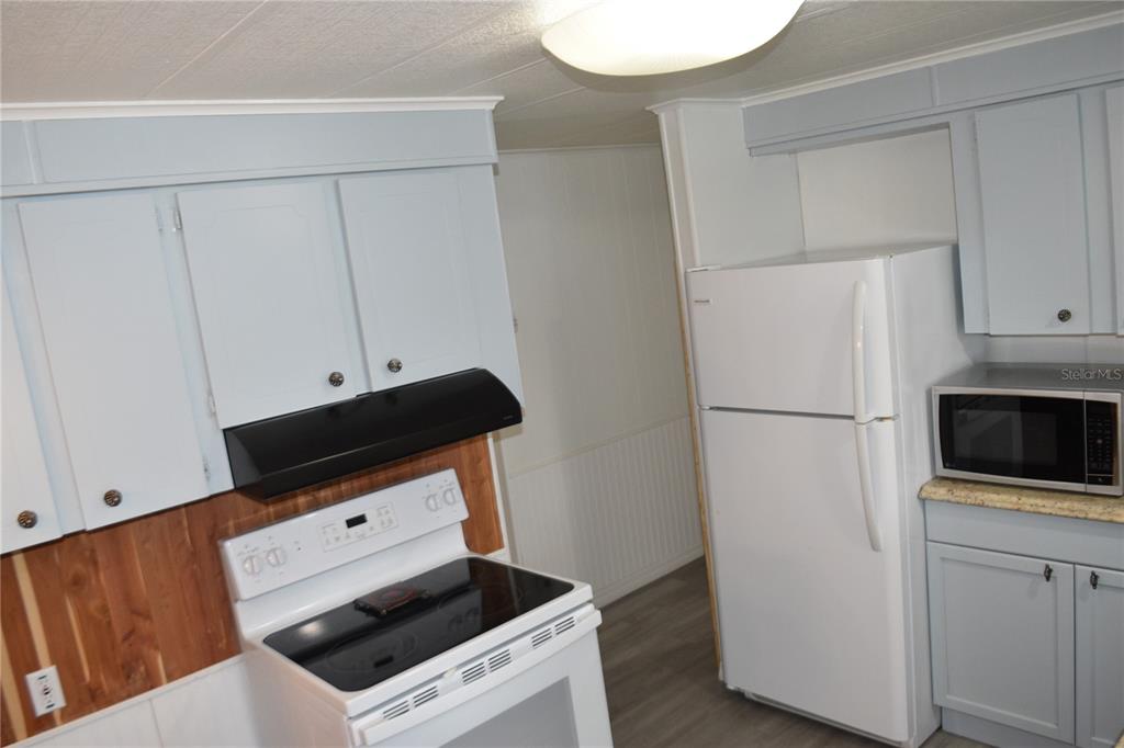 4407 Tucker Square New Port Richey, FL 34652 - Photo 26 of 69 a room with furniture and a refrigerator
