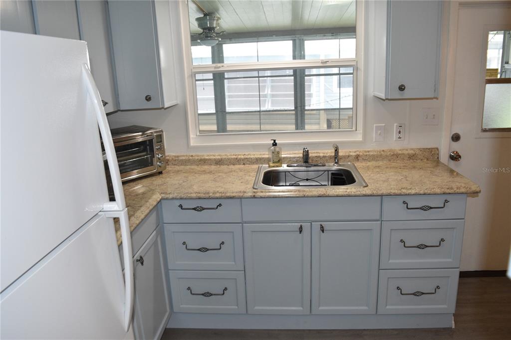 4407 Tucker Square New Port Richey, FL 34652 - Photo 28 of 69 a kitchen with cabinets appliances and a window