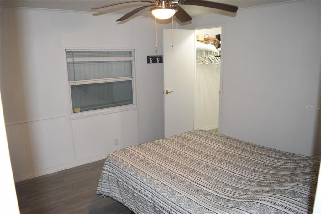 4407 Tucker Square New Port Richey, FL 34652 - Photo 38 of 69 a bedroom with a bed and a chandelier fan