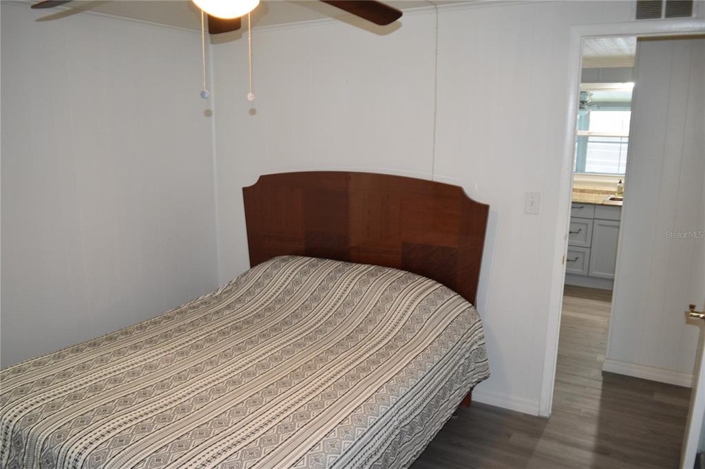 4407 Tucker Square New Port Richey, FL 34652 - Photo 39 of 69 a bedroom with a bed and wooden floor