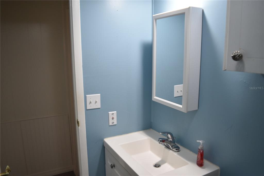 4407 Tucker Square New Port Richey, FL 34652 - Photo 48 of 69 a bathroom with a sink and mirror