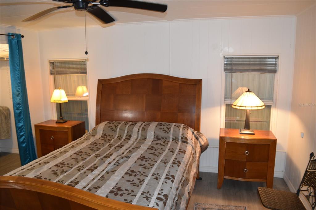 4407 Tucker Square New Port Richey, FL 34652 - Photo 50 of 69 a bedroom with a bed and wooden floor