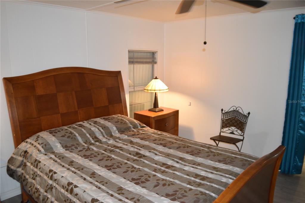 4407 Tucker Square New Port Richey, FL 34652 - Photo 53 of 69 a bedroom with a bed and a lamp