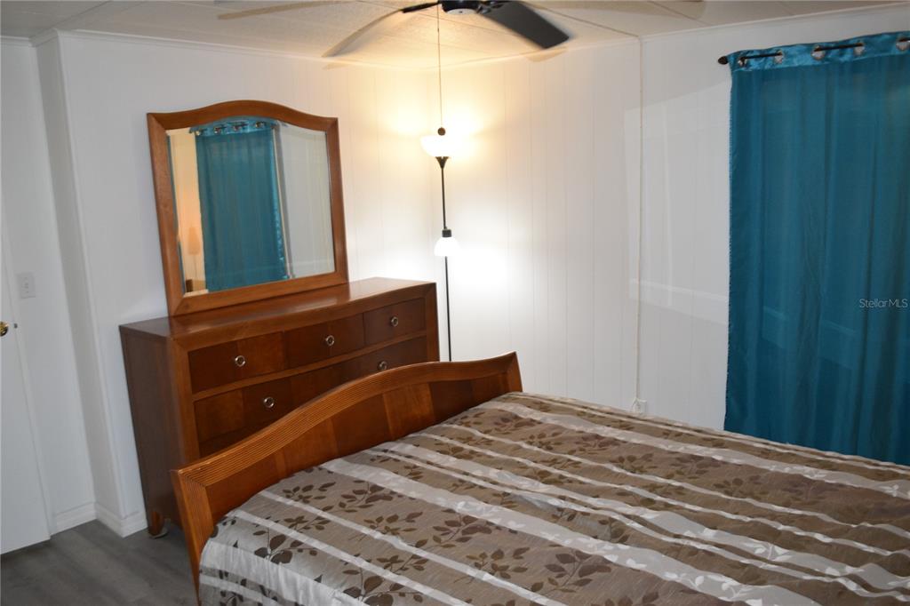 4407 Tucker Square New Port Richey, FL 34652 - Photo 56 of 69 a bedroom with a bed and a mirror