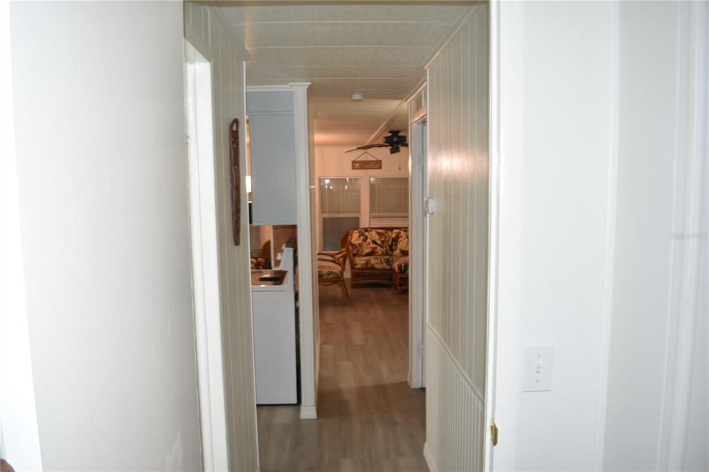 4407 Tucker Square New Port Richey, FL 34652 - Photo 58 of 69 a view of a hallway with wooden floor fireplace and living room