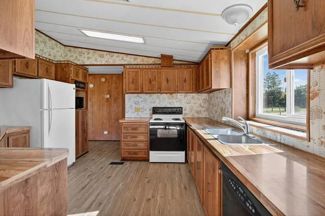 a kitchen with stainless steel appliances granite countertop a stove and a refrigerator